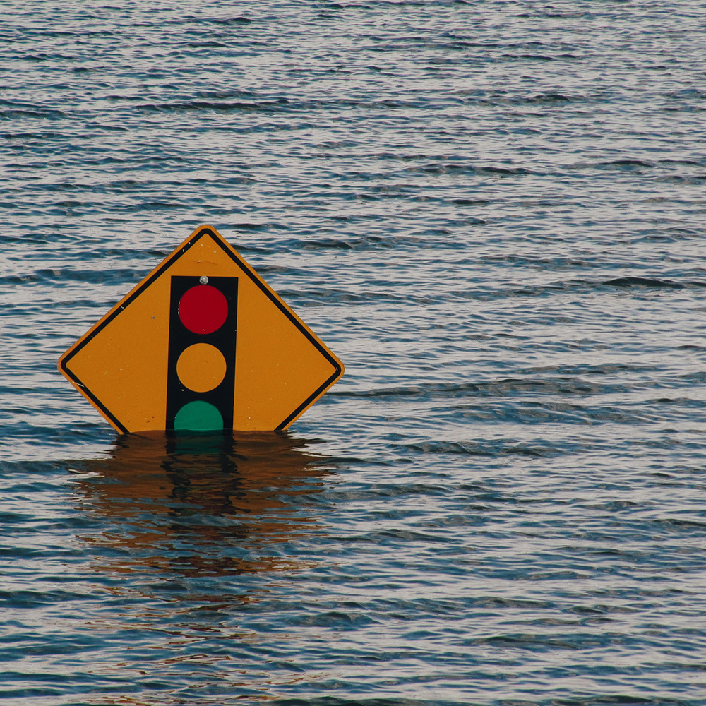 Image of a stop sign underwater due to flooding