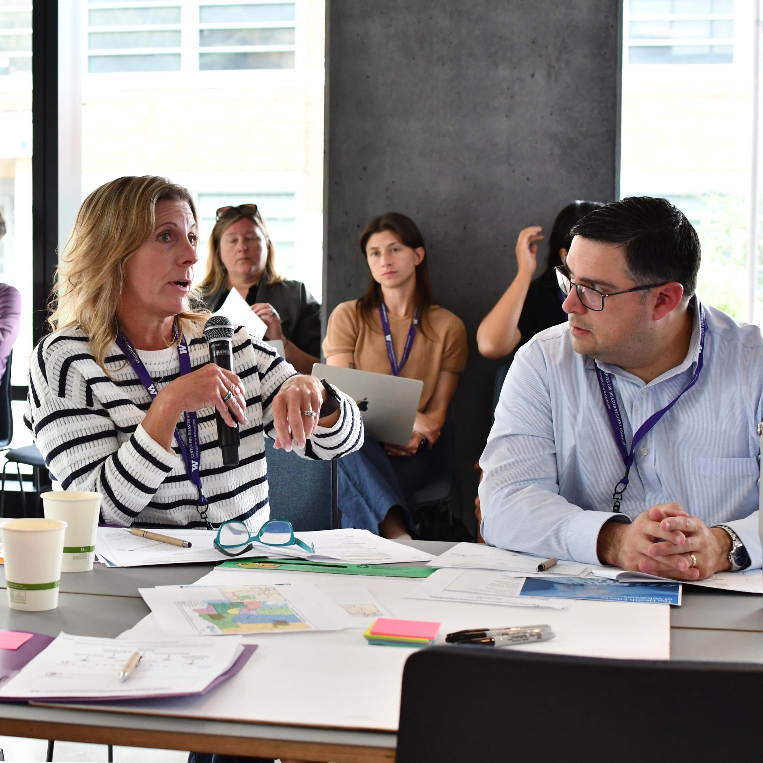 An attendee uses a microphone to answer a question