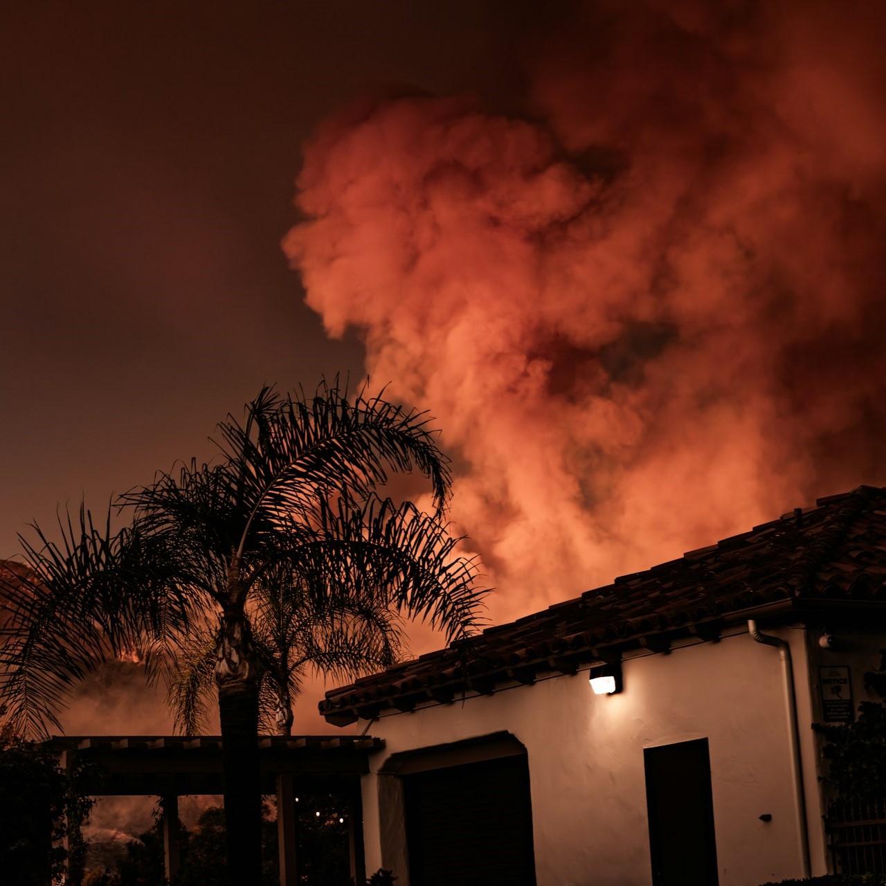 A wildfire burns toward homes