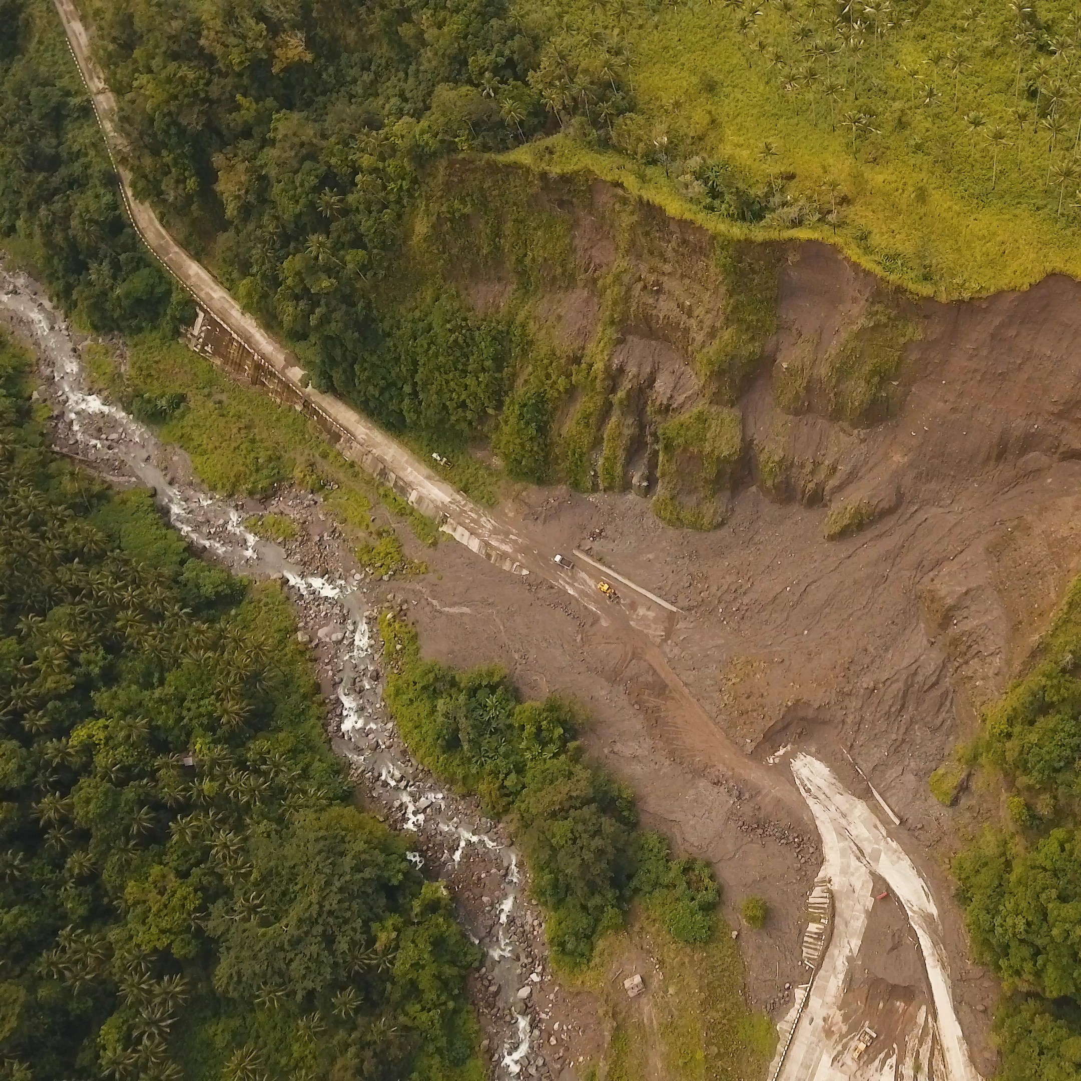A landslide covers a road in the mountains