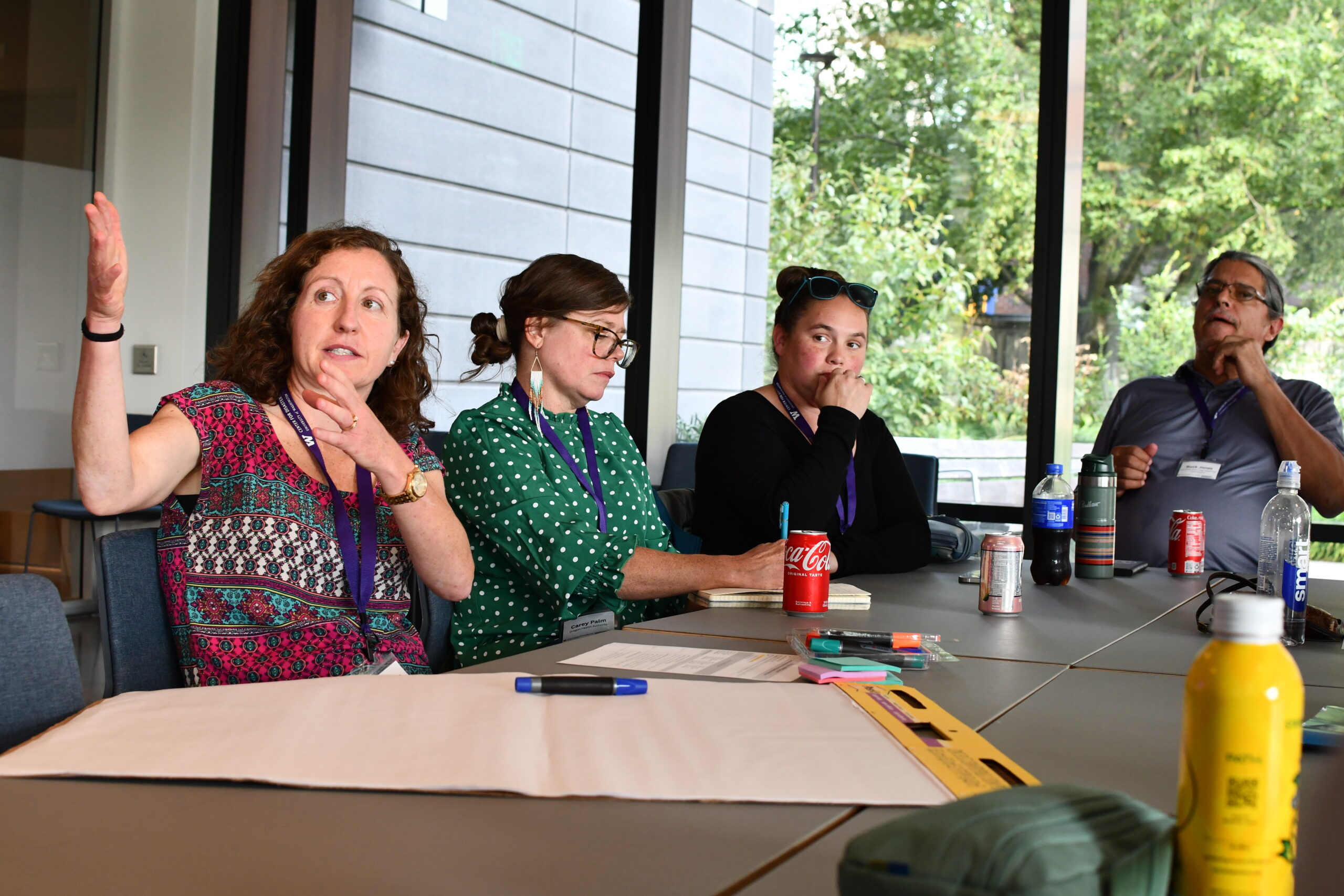 A group of conference attendees shares ideas with each other while seated at a table