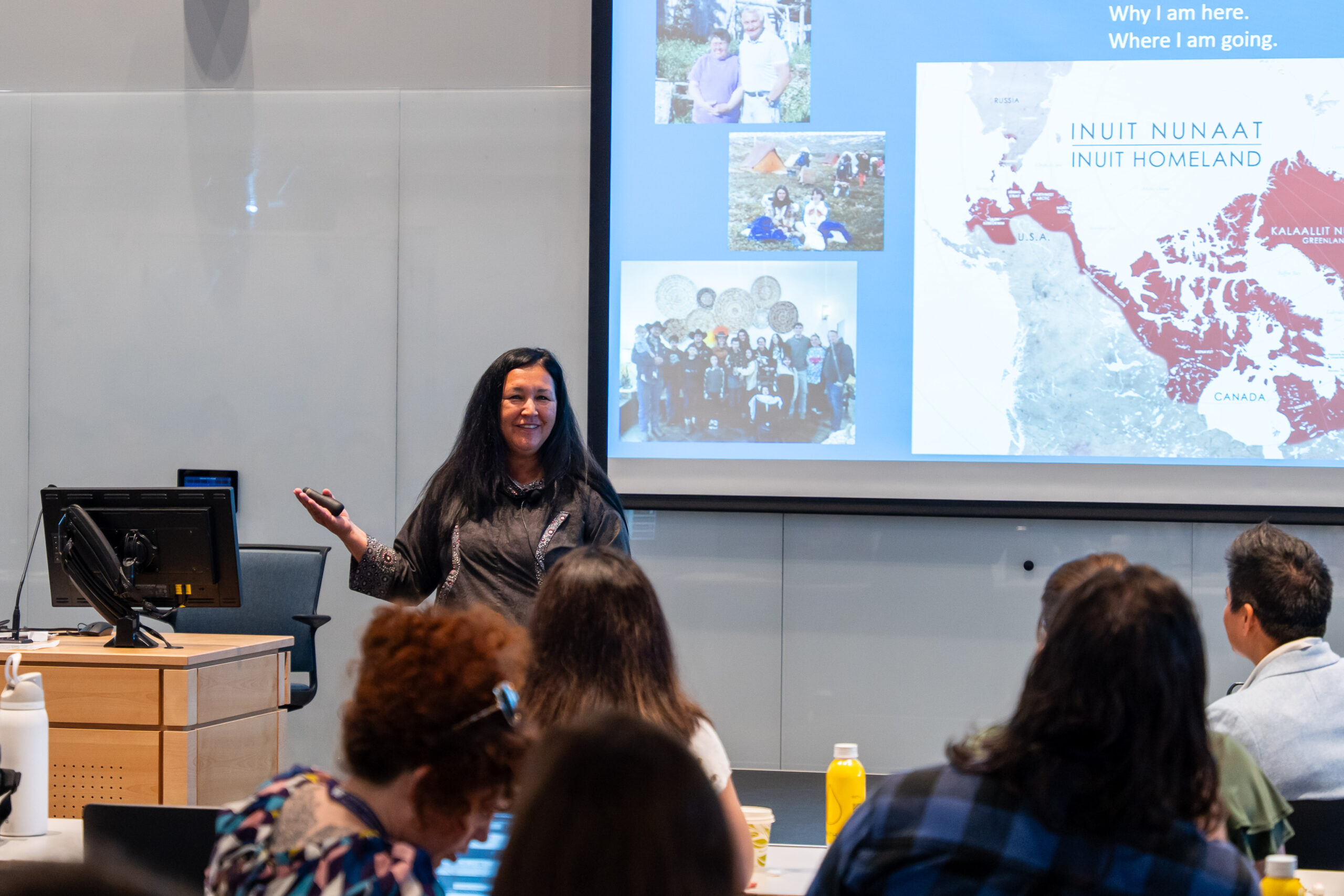Jackie Qataliña Schaeffer of the Alaska Native Tribal Health Consortium gives a keynote address from a podium to a seated audience