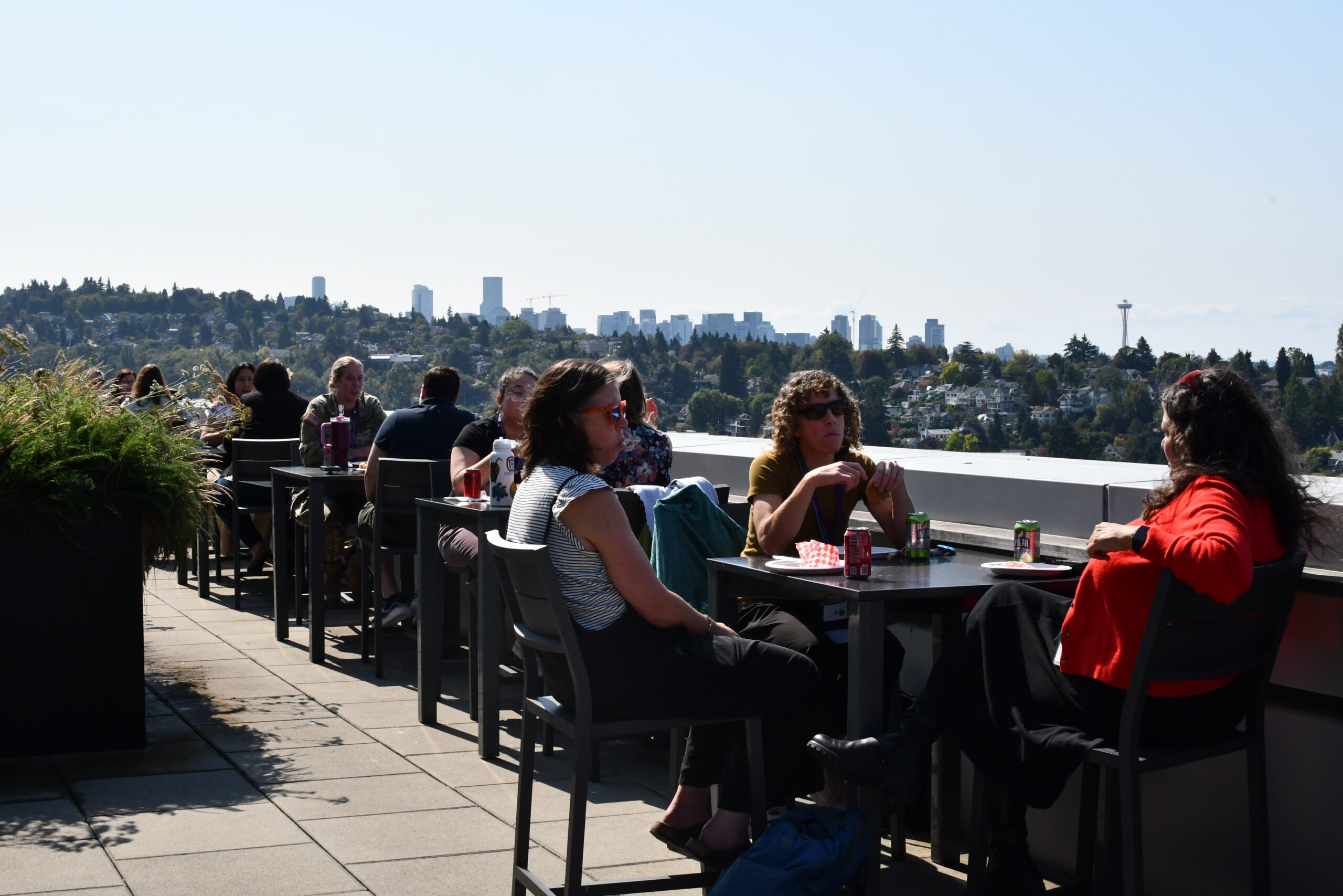 Conference attendees featured on a rooftop deck during a lunch break