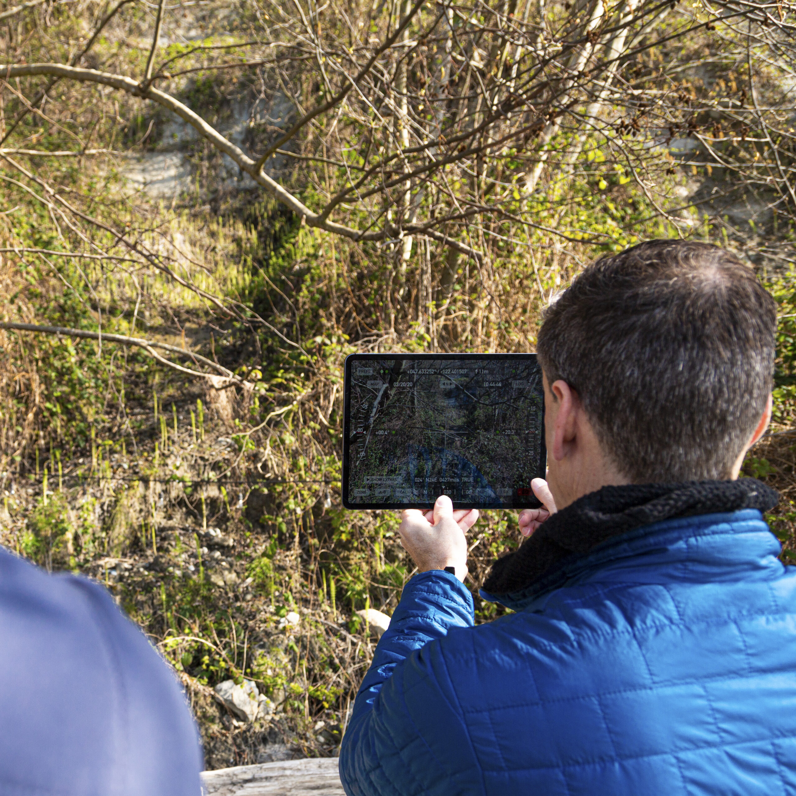 A UW researcher compares a computer model and maps with real time assessment of landslide areas in Seattle area